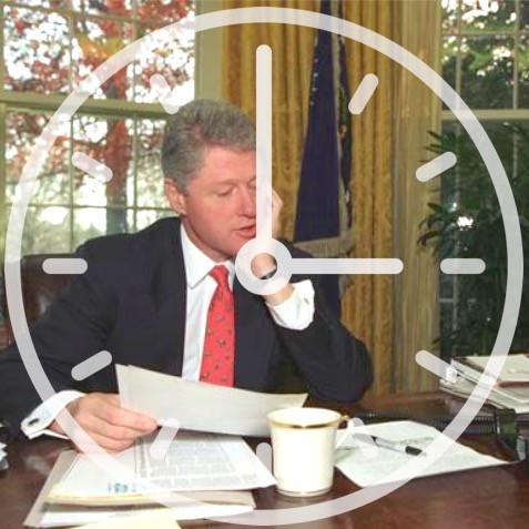 photo of Bill Clinton seated at the Presidential Desk