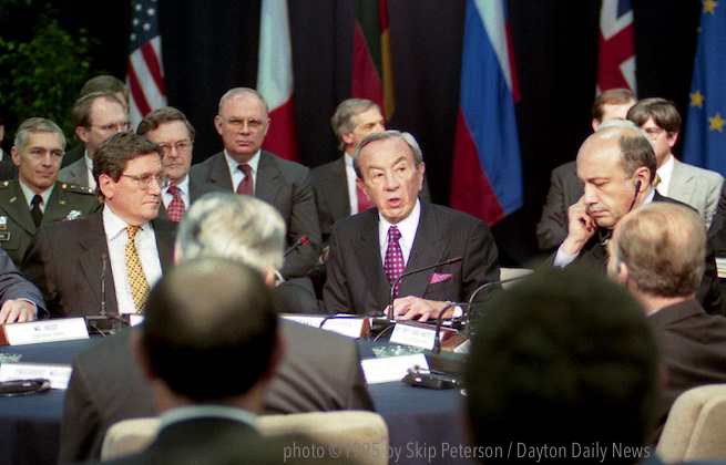 photo of all of the leaders seated in the negotiating room, centered on Secretary of State Warren Christopher.