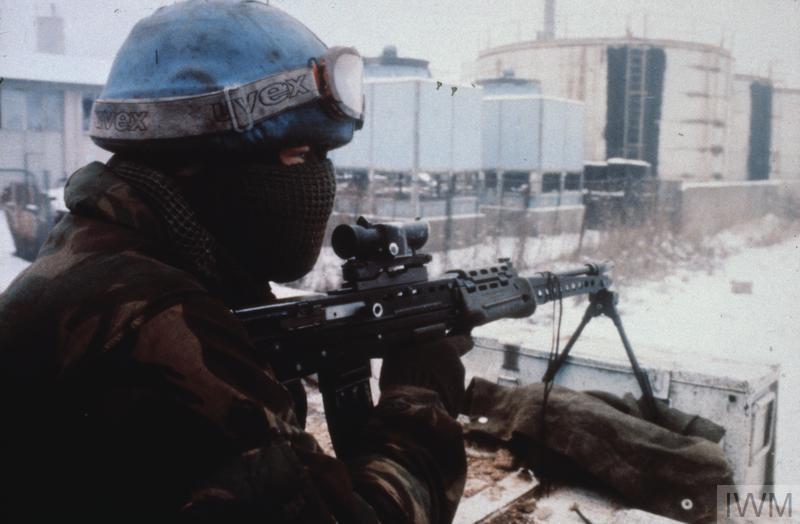 photo of a soldier with a machine gun